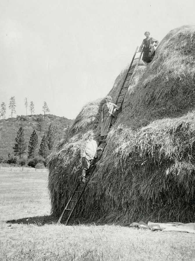 Mrs. Adams shows her friends how climb a haystack